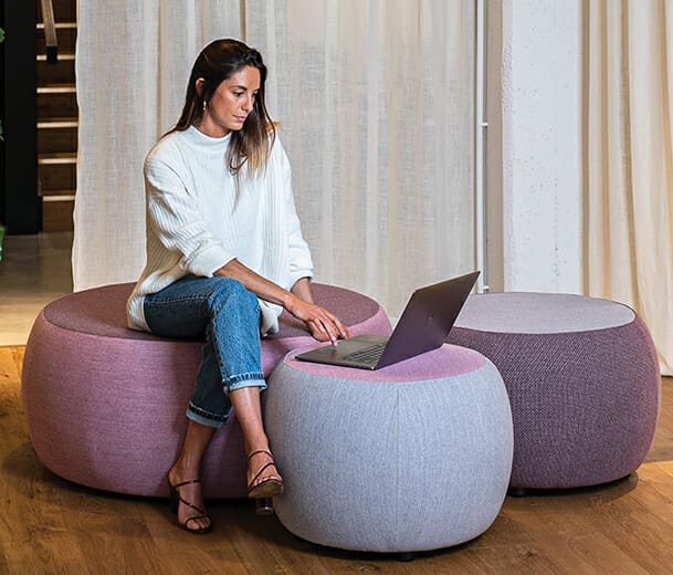 Konfurb Halo ottomans with female working on laptop 