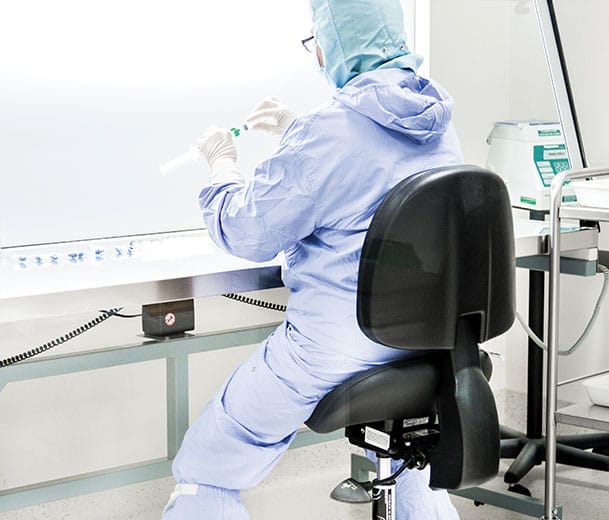 Laboratory technician sitting on a Buro Bambach stool with back