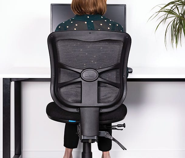 Back view of a woman seated in a Buro Metro ergonomic office chair at a desk