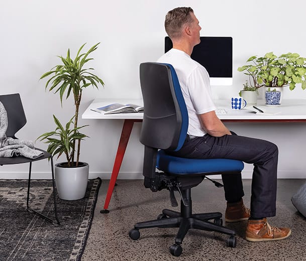 Man seated in Buro Roma 3 Lever Mid Back ergonomic office chair in home office scene