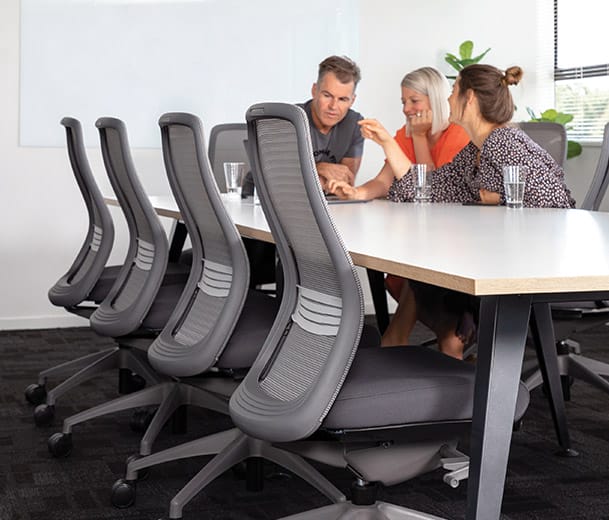 Office boardroom scene with Konfurb Luna chairs and people sitting at the end of the table