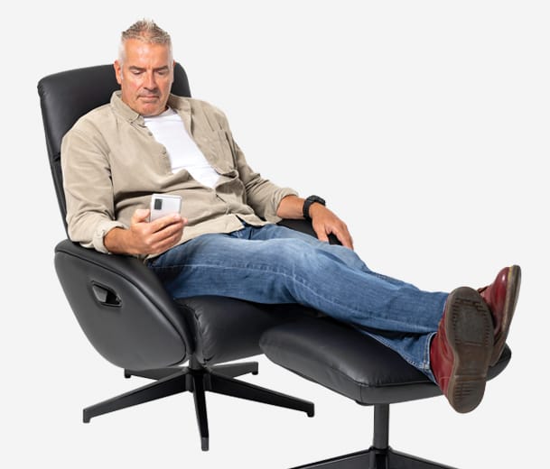 Man sitting in Buro Maya recliner looking at cell phone