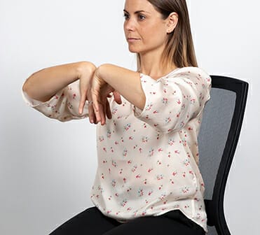 woman doing an office wrist stretch