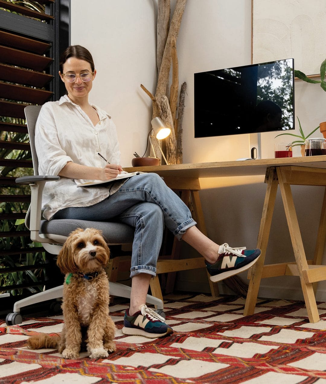 wfh-ergonomic-chair girl and dog working from home sitting on ergonomic chair