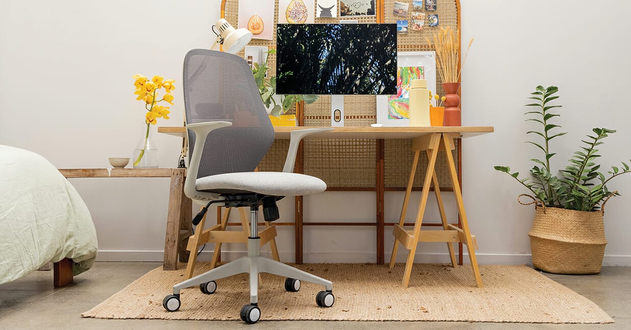 A work-from-home setup and mesh-backed desk chair