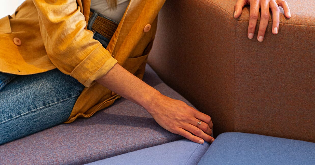 woman's hand on NZ Made Konfurb seating with NZ fabrics