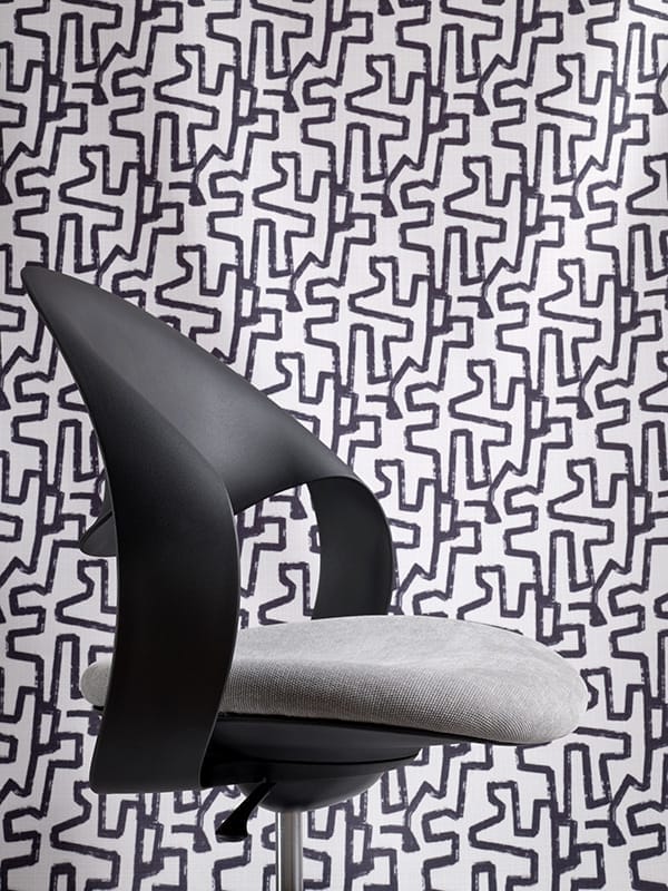 Konfurb Loop chair upholstered in Warwick Copeland Gull and background Easton Jet fabrics