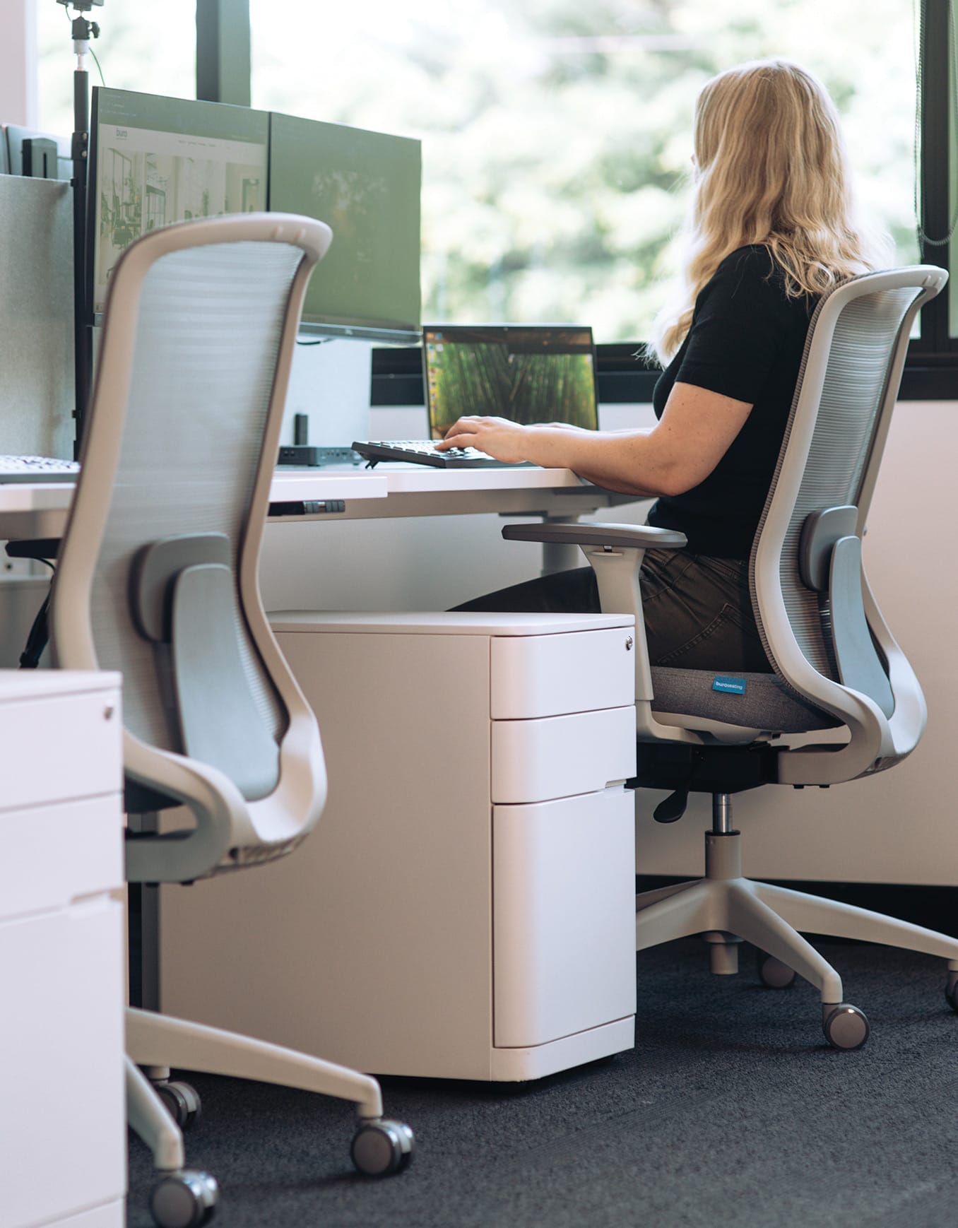 woman sitting at a standing desk